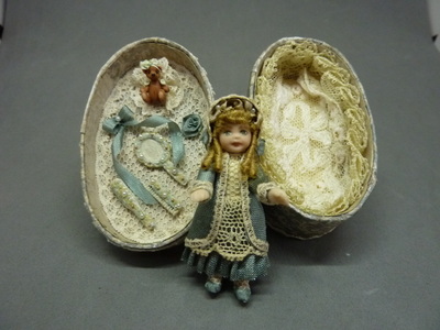 Doll in an oval box
